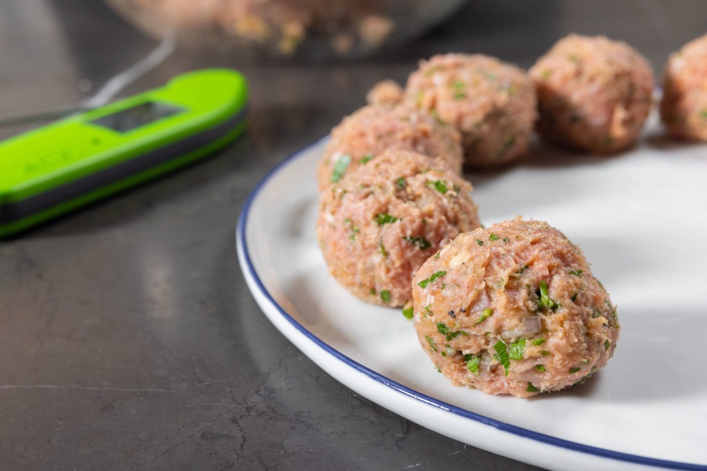 portioned meatballs on a plate ready to cook