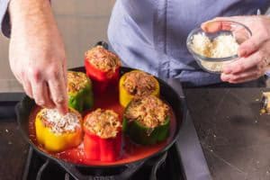 Topping the peppers with parm