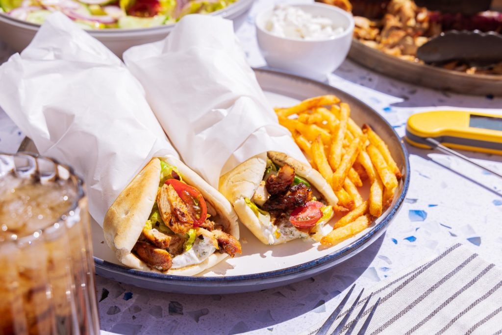 Chicken shawarma on a plate with fries and tomatoes