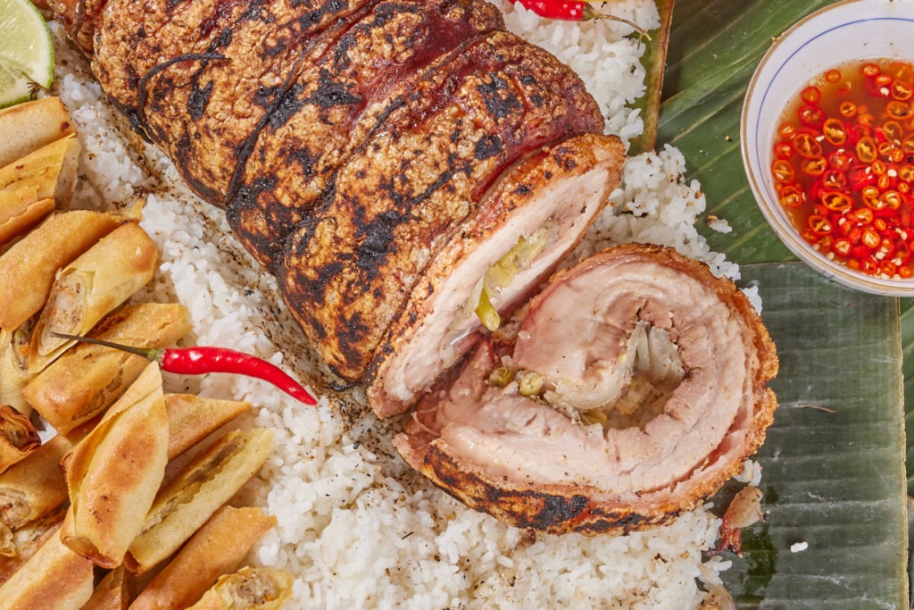 Crisp-skinned pork belly on rice with accompaniments