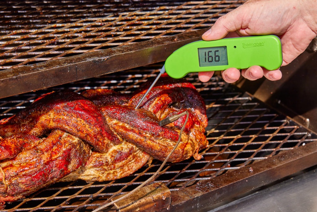 temping the pork belly braid with Thermapen ONE