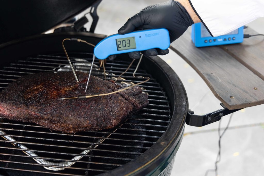 Verifying the temperature on an unwrapped brisket