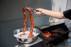 the links, smoked, held above an ice bath