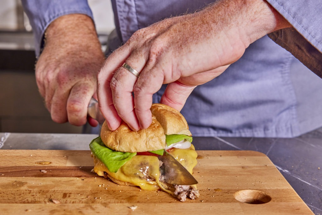 Slicing a stuffed burger in half