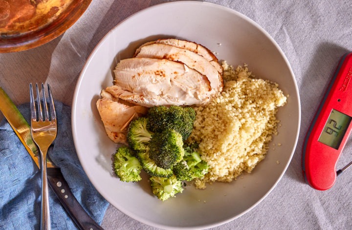 A plate of smoked chicken with couscous and broccoli