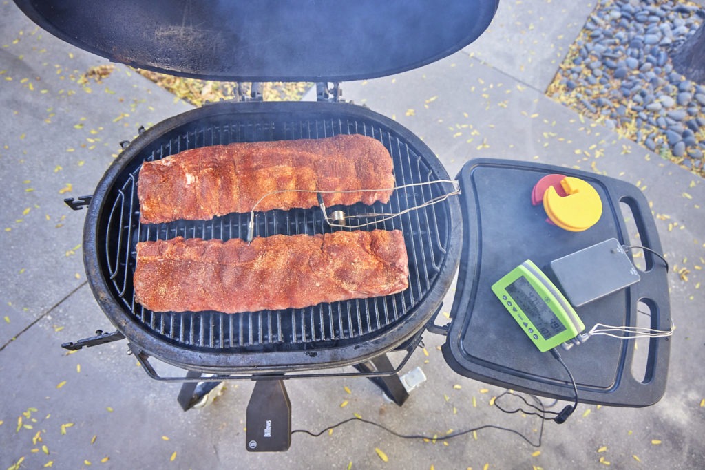 Ribs on a smoker, probed, and ready to smoke