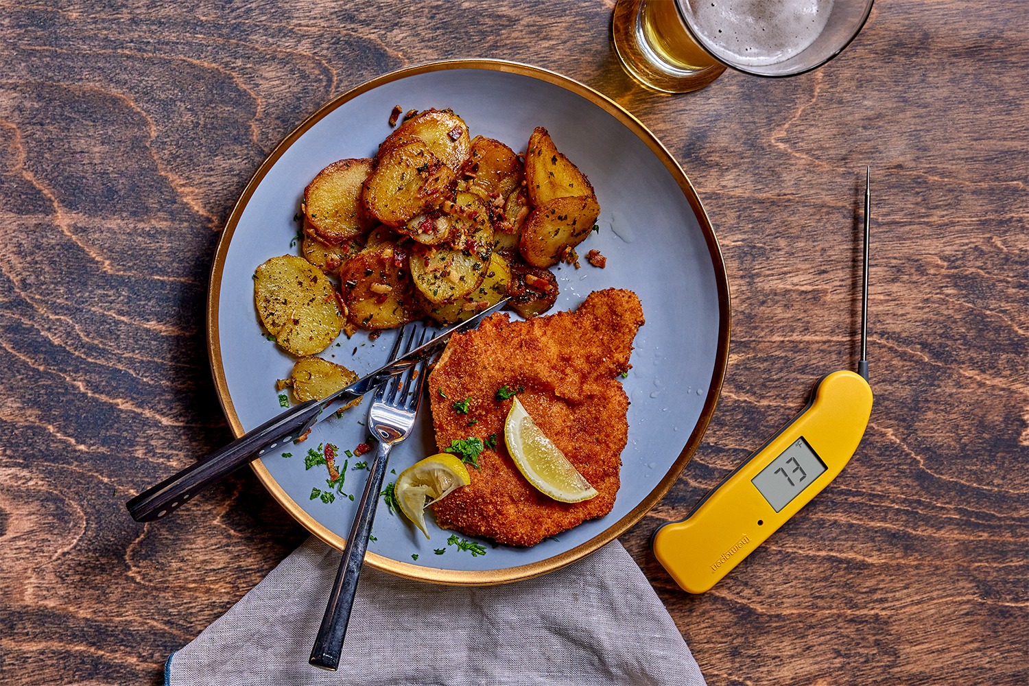 A plate of schnitzel with a beverage and a Thermapen