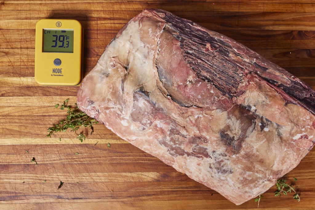 A dry-aged loin of beef with a NODE thermometer and humidity monitor