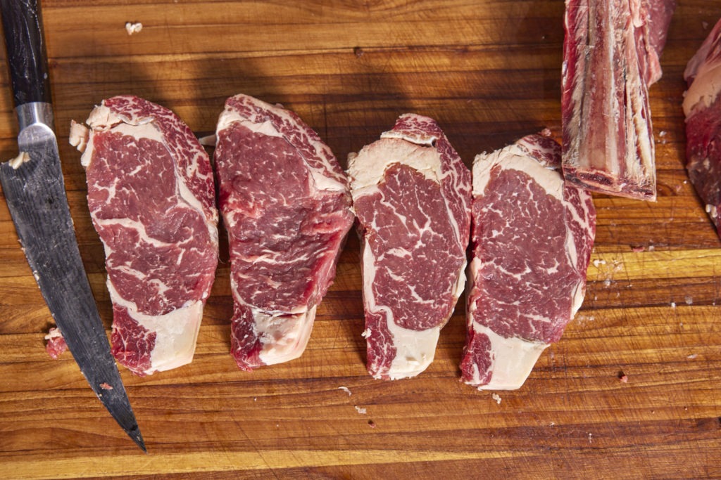 Four boneless, dry-aged beef ribeye steaks