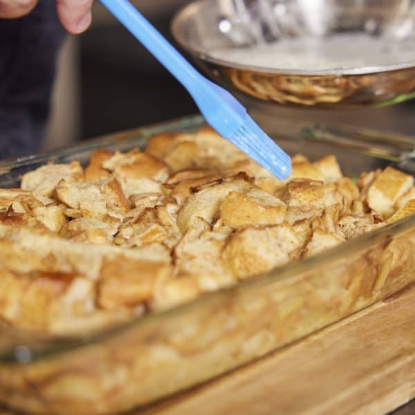 Brushing butter on bread pudding