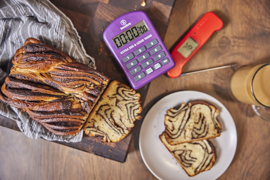 Babka, timer, thermometer, cup of milky coffee