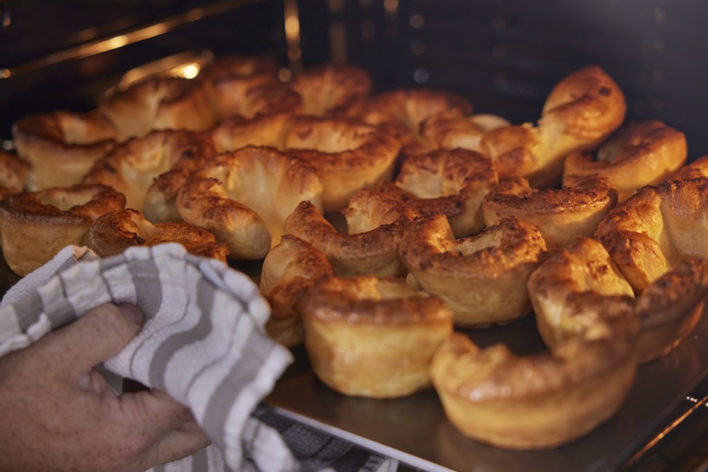 Yorkshire puddings being pulled from the oven