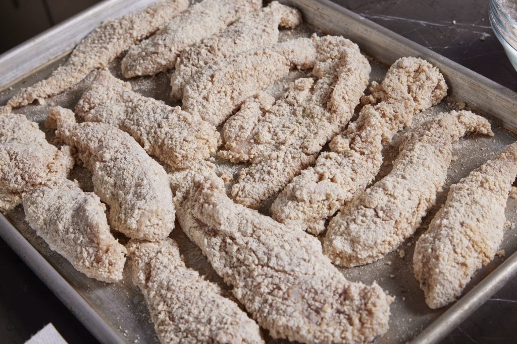 Breaded, uncooked chicken strips