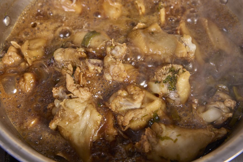 the wings braising in the savory broth