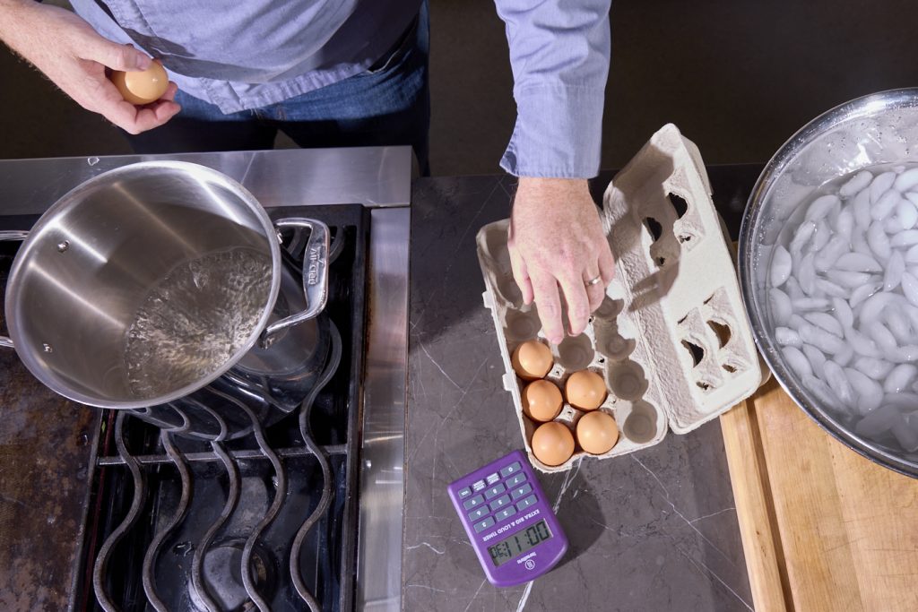 Timer set to boil eggs, ice bath, eggs, boiling water