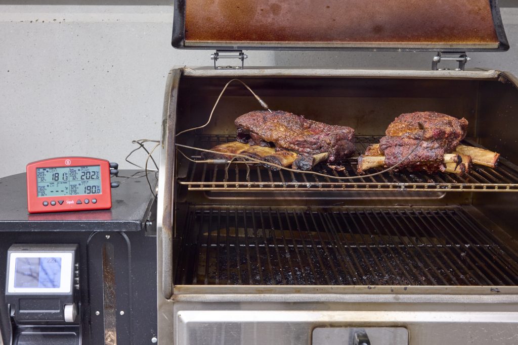 short rib son smoker with thermometer plugged in
