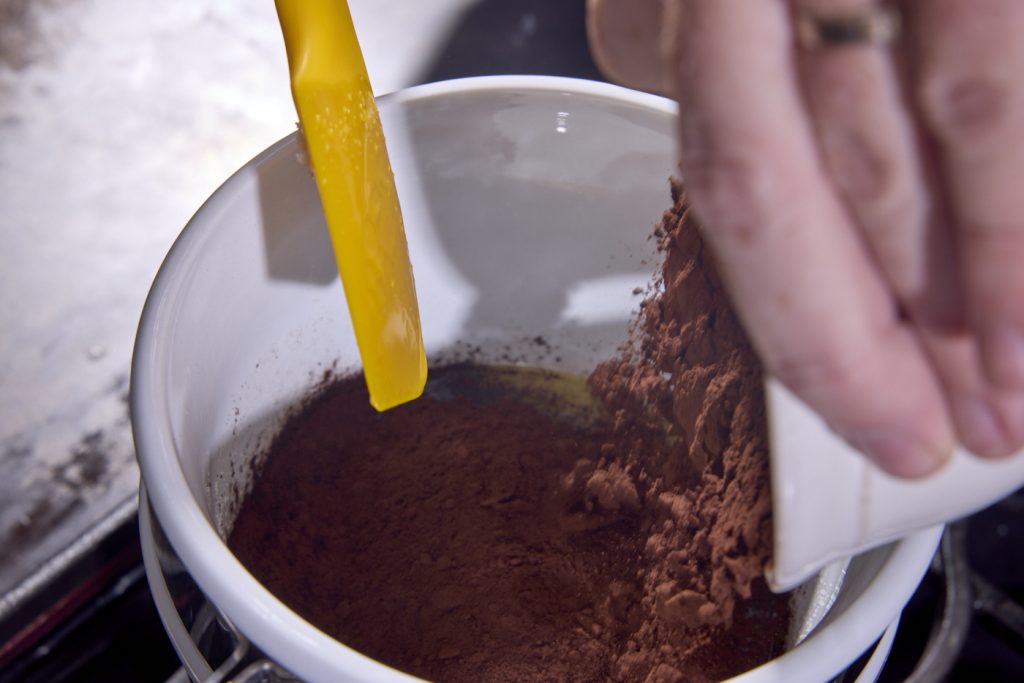 adding cocoa to the pot