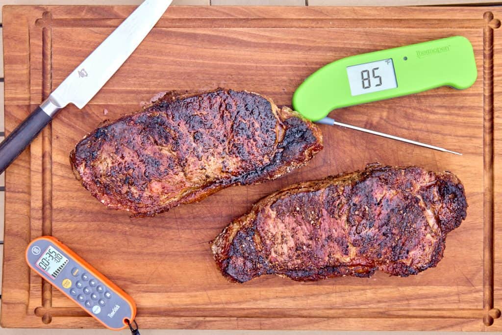 Koji-aged steaks with thermometer, timer, and knife