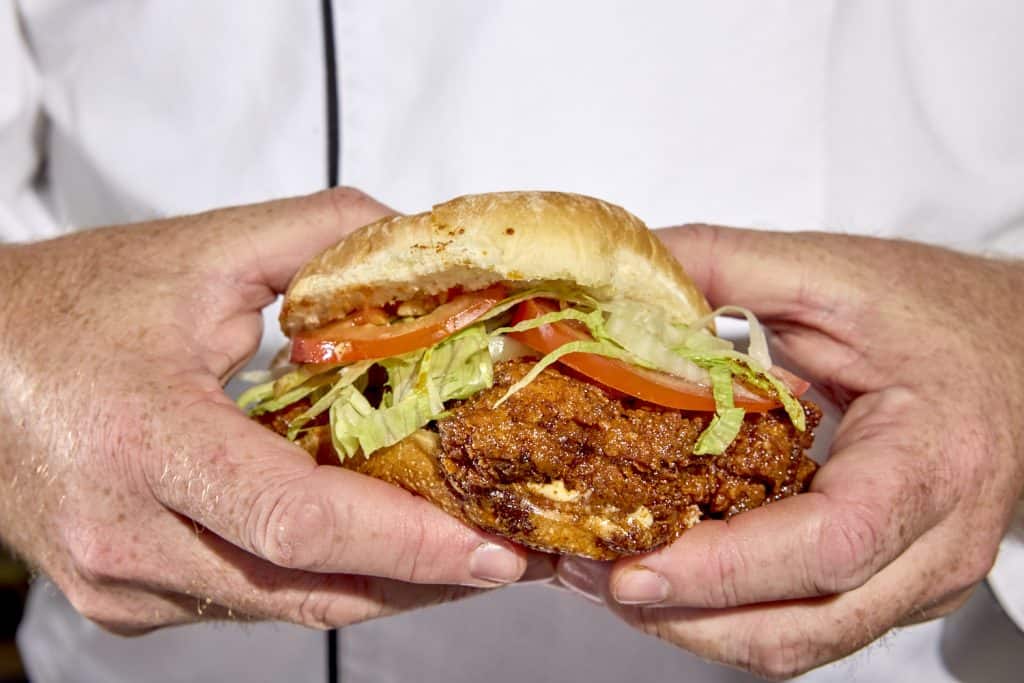 Spicy chicken sandwich in hand