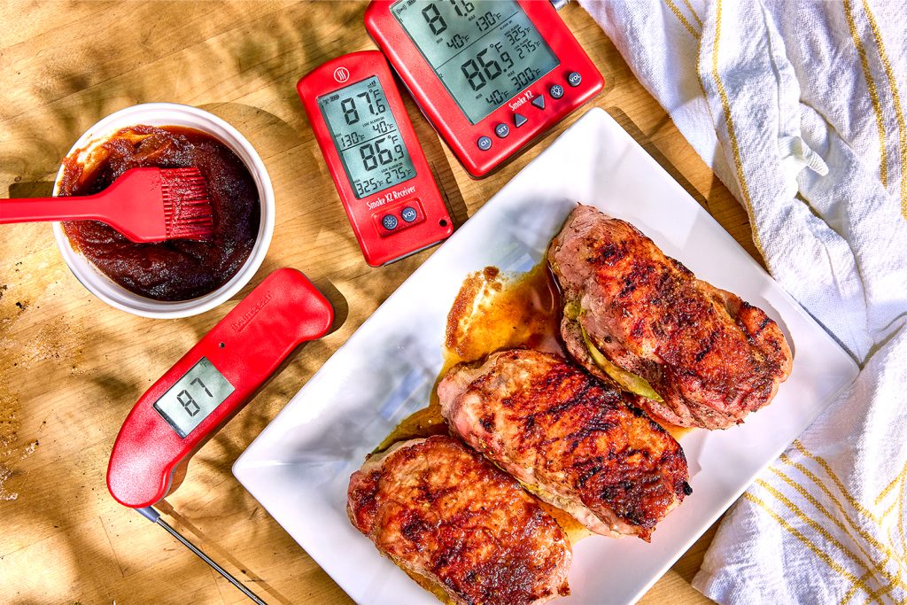 Thick cut pork chops with thermometers and apple butter