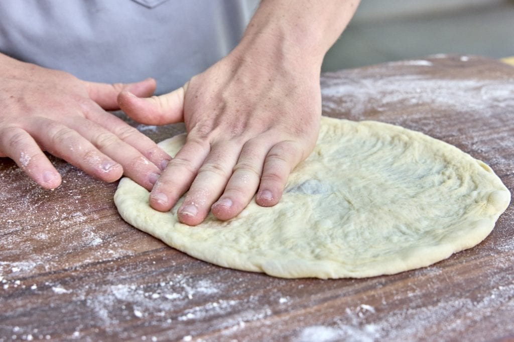 shaping pizza dough for grilling