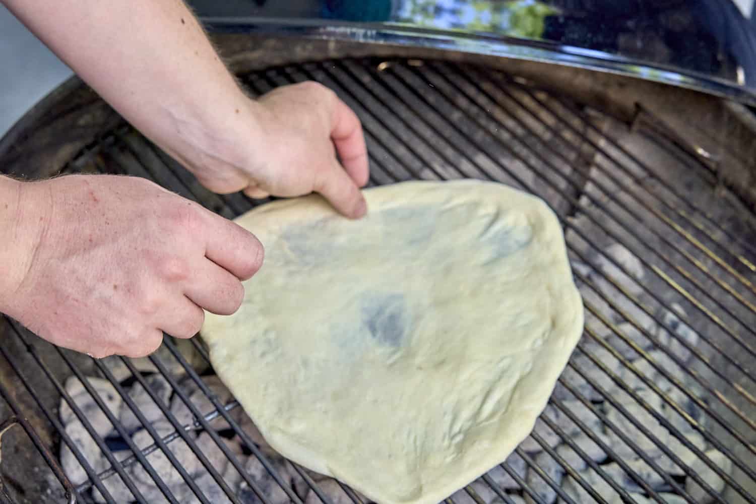 Putting dough on the grill