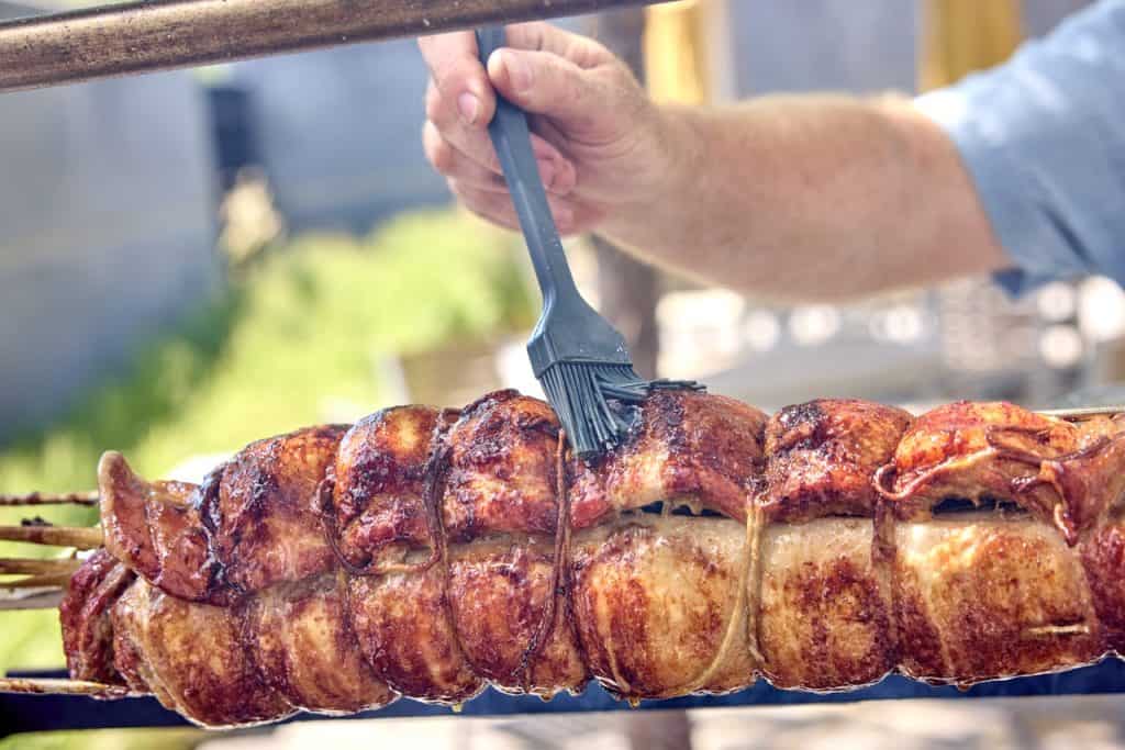 Brushing the pork belly with oil