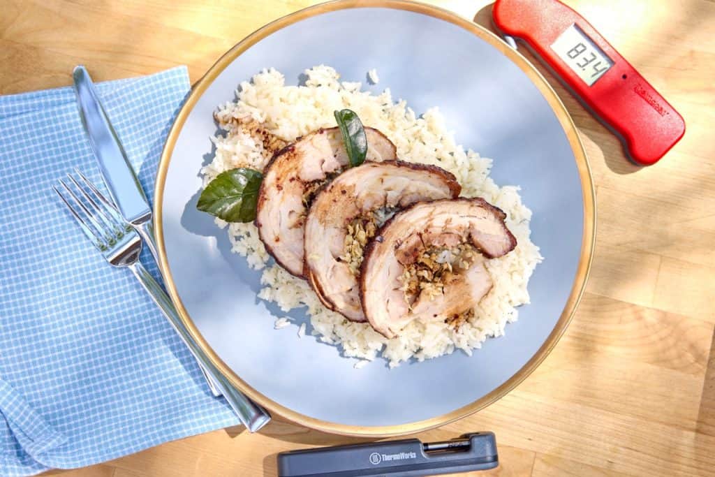 Sliced pork belly on rice with thermometers accompanying