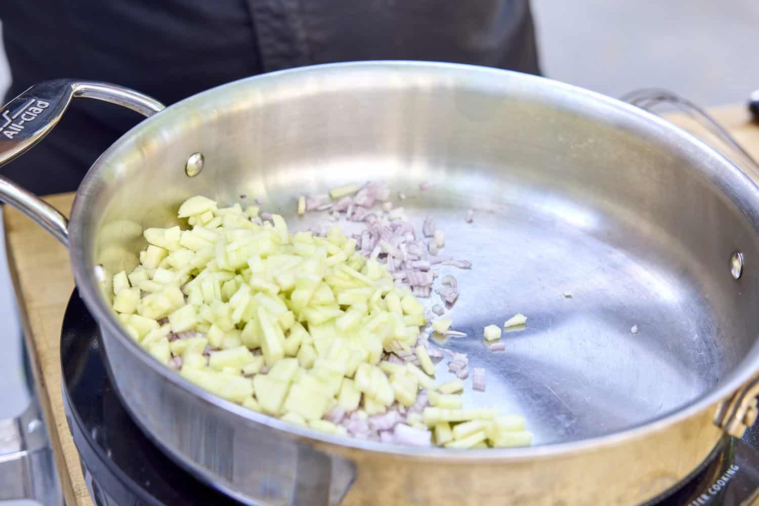 Apples and shallot in a pan