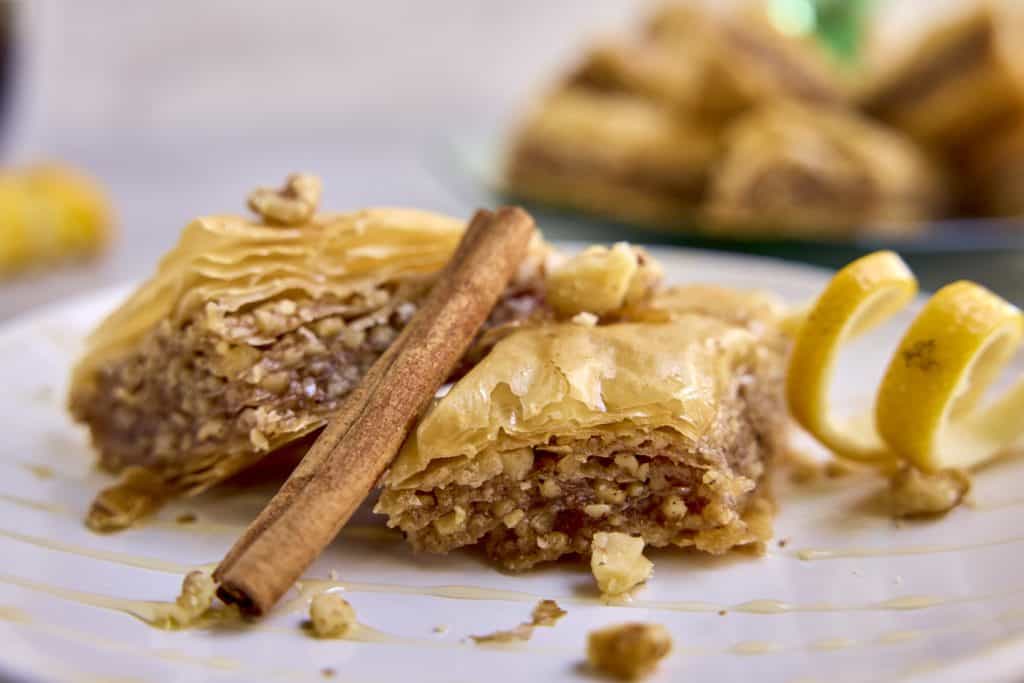 baklava with a cinnamon stick leaning on it