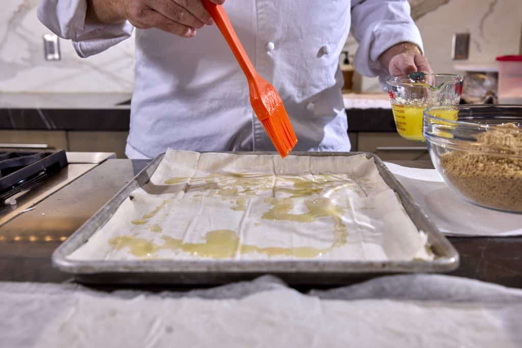 Drizzling butter on with a silicone brush