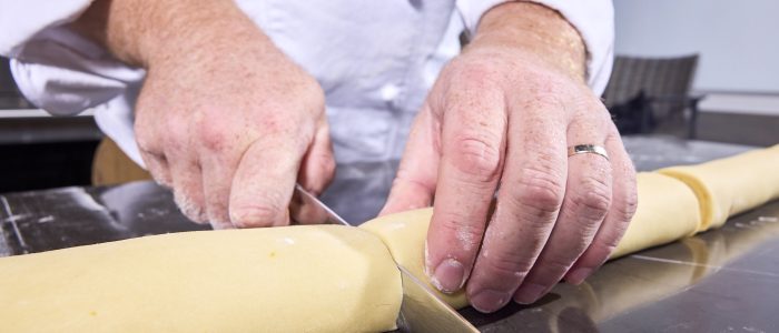 cutting the dough log into portions