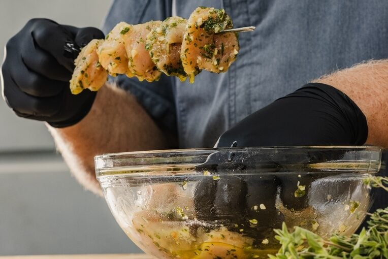 threading chicken chunks onto skewer