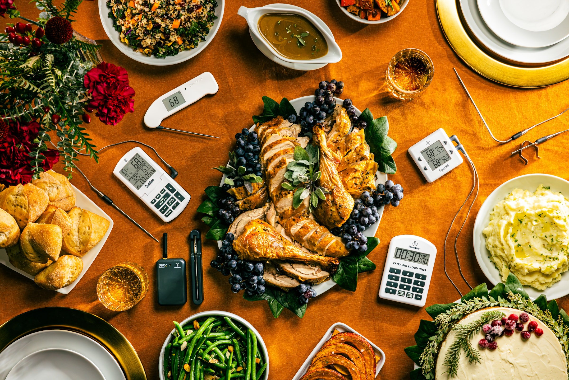 A whole thanksgiving feast with thermometers on the table