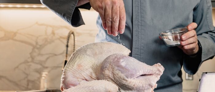 salting the skin of the turkey