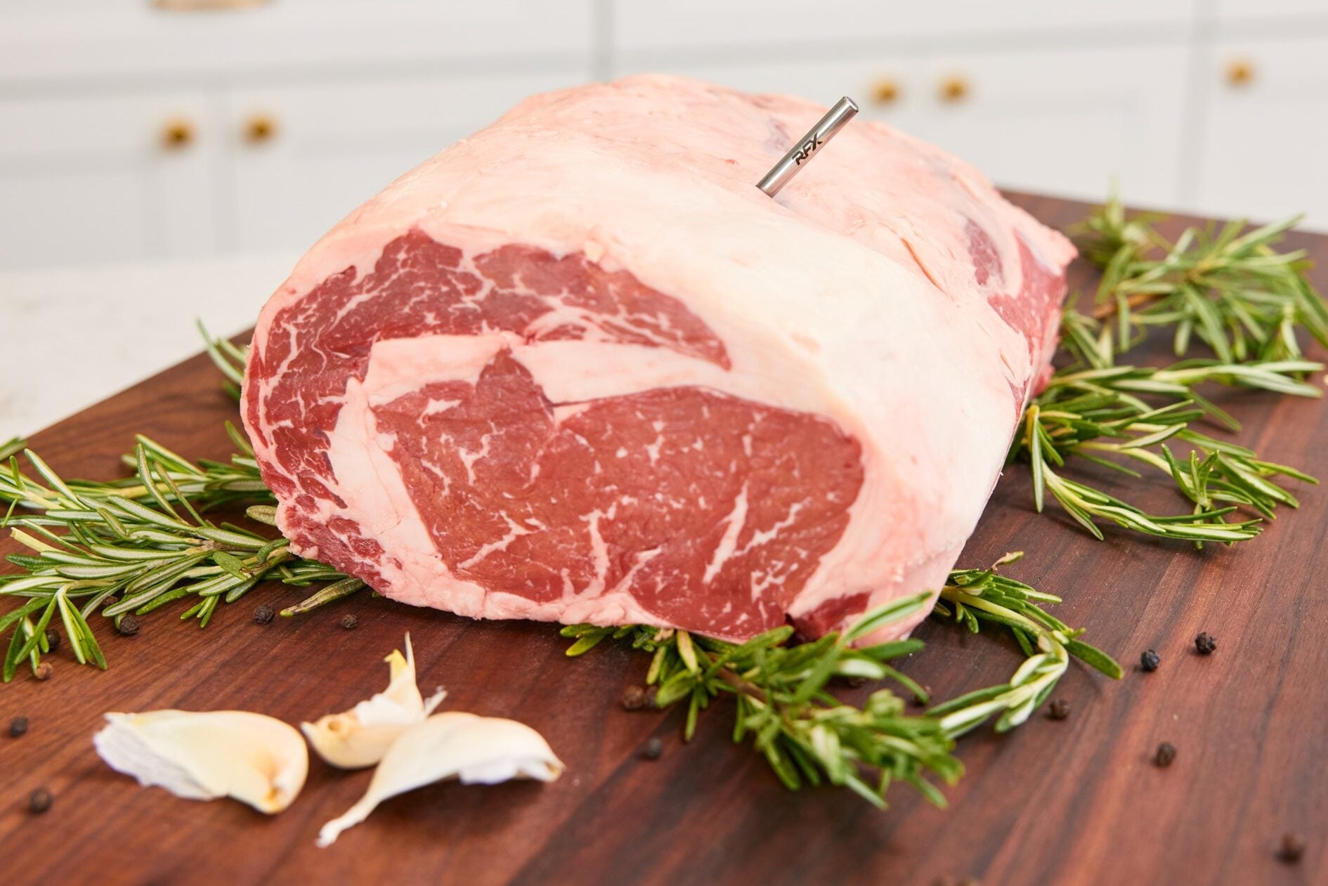 ribeye roast on cutting board, raw, with RFX MEAT inserted